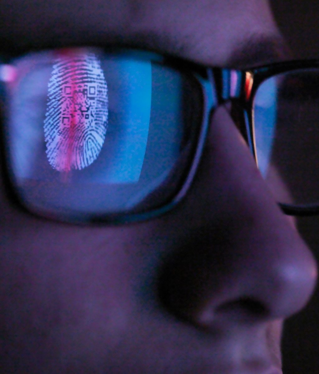 Cyber Security, reflection in spectacles of access information being scanned on computer screen